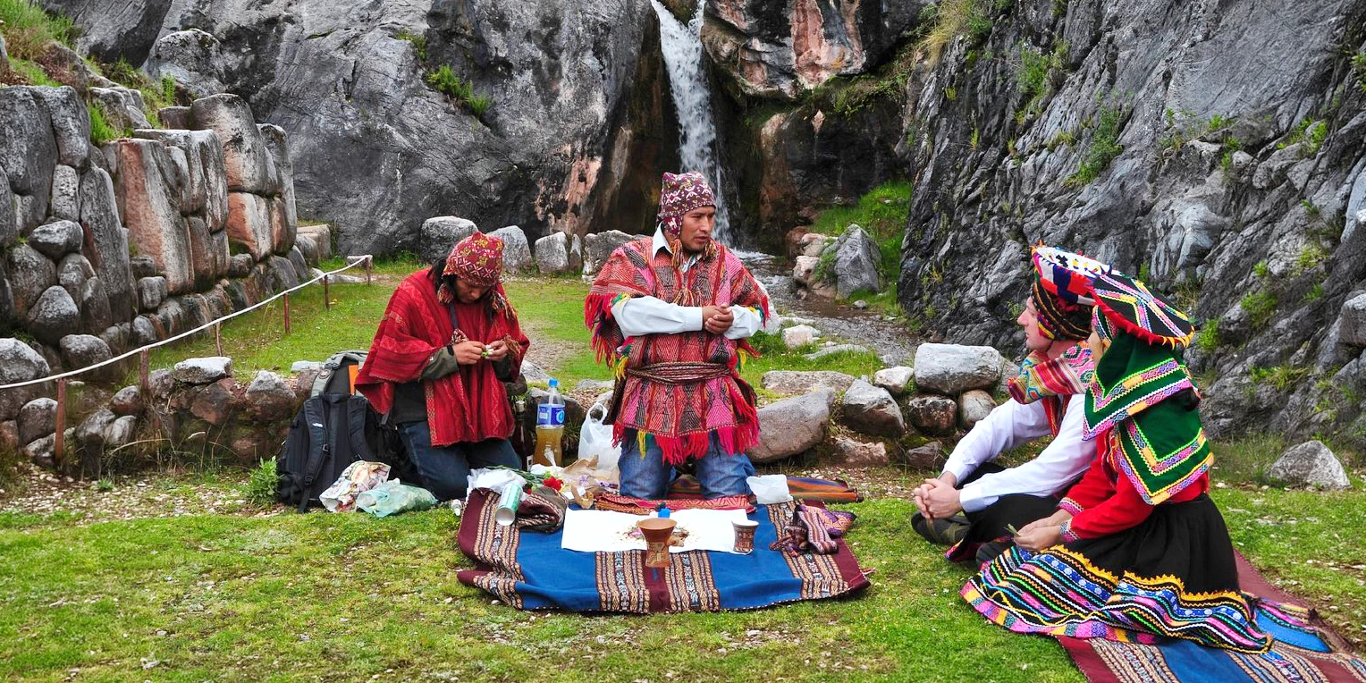 Close-up of a traditional ceremony where participants offer coca leaves to Pachamama (Mother Earth) in the mountains of Peru.