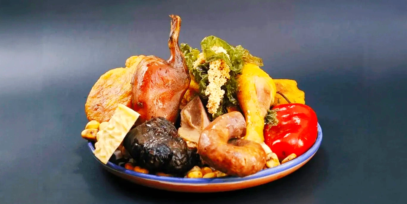 A complete serving of Chiriuchu, the iconic cold dish of Cusco featuring roasted guinea pig, chicken, jerky, and seaweed.