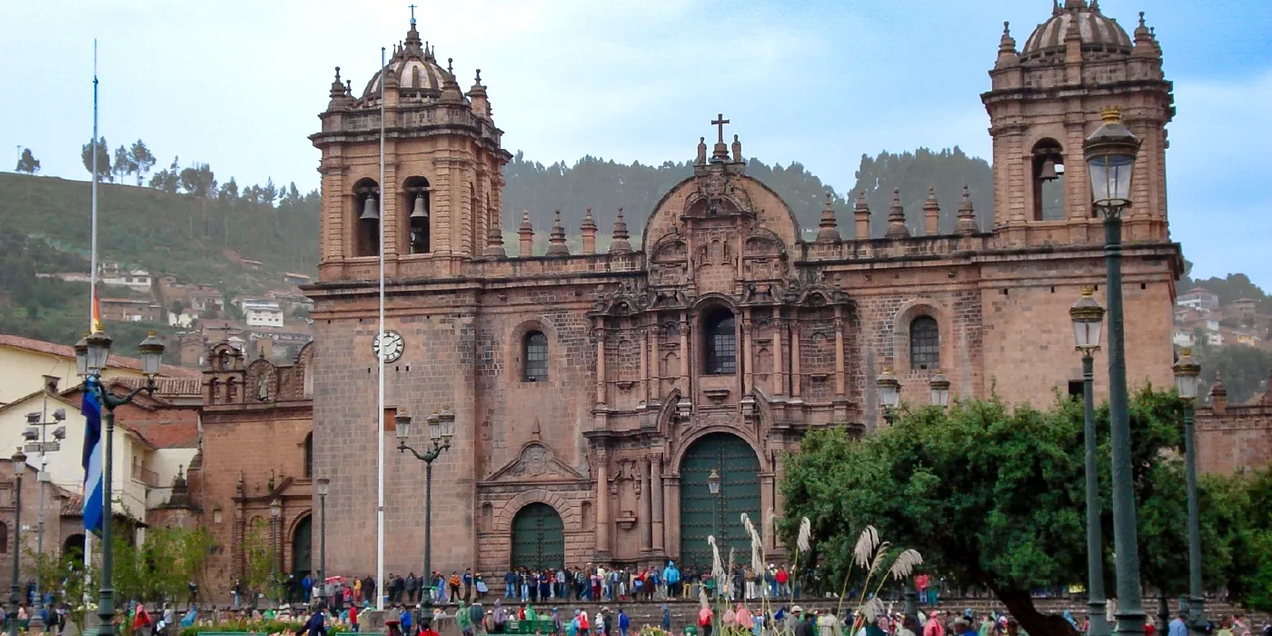 Impressive colonial architecture of the Cusco Cathedral in the Plaza de Armas with people gathering
