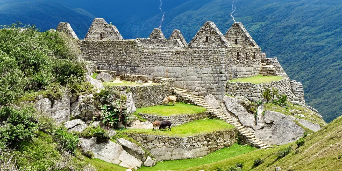 Close-up of perfectly preserved Inca stone houses and steep agricultural terraces at the Machu Picchu archaeological site.