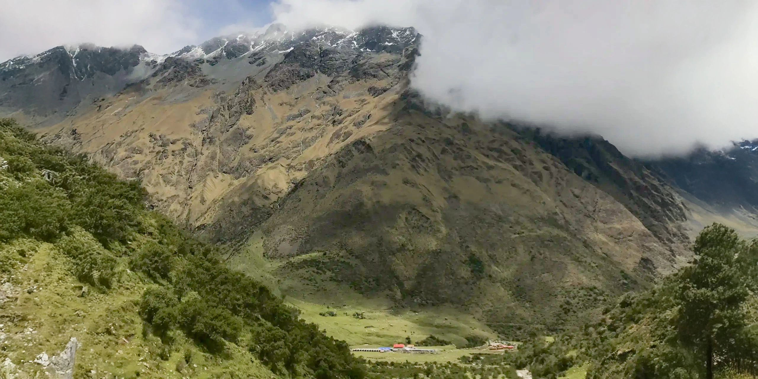 Panoramic view of the mist-covered Andean mountains in Peru, showcasing the rugged landscape significant to Inca astronomy.