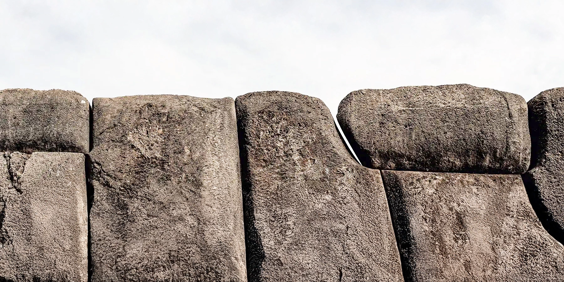 Close-up of perfectly fitted large stones in an Inca wall, showcasing ancient megalithic architecture in Peru.