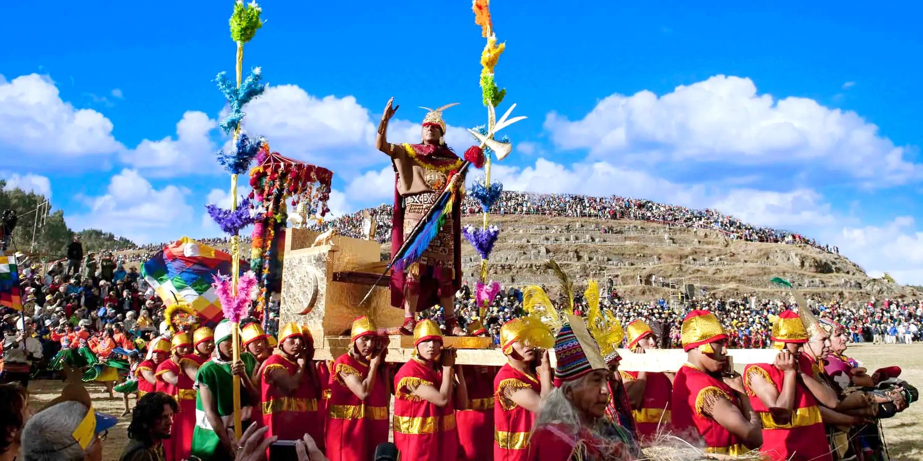 The Sapa Inca actor standing on a golden litter during the Inti Raymi ceremony at Sacsayhuaman.