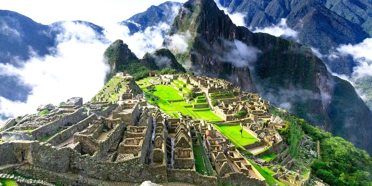 Iconic aerial view of the citadel of Machu Picchu and Huayna Picchu mountain, shrouded in clouds