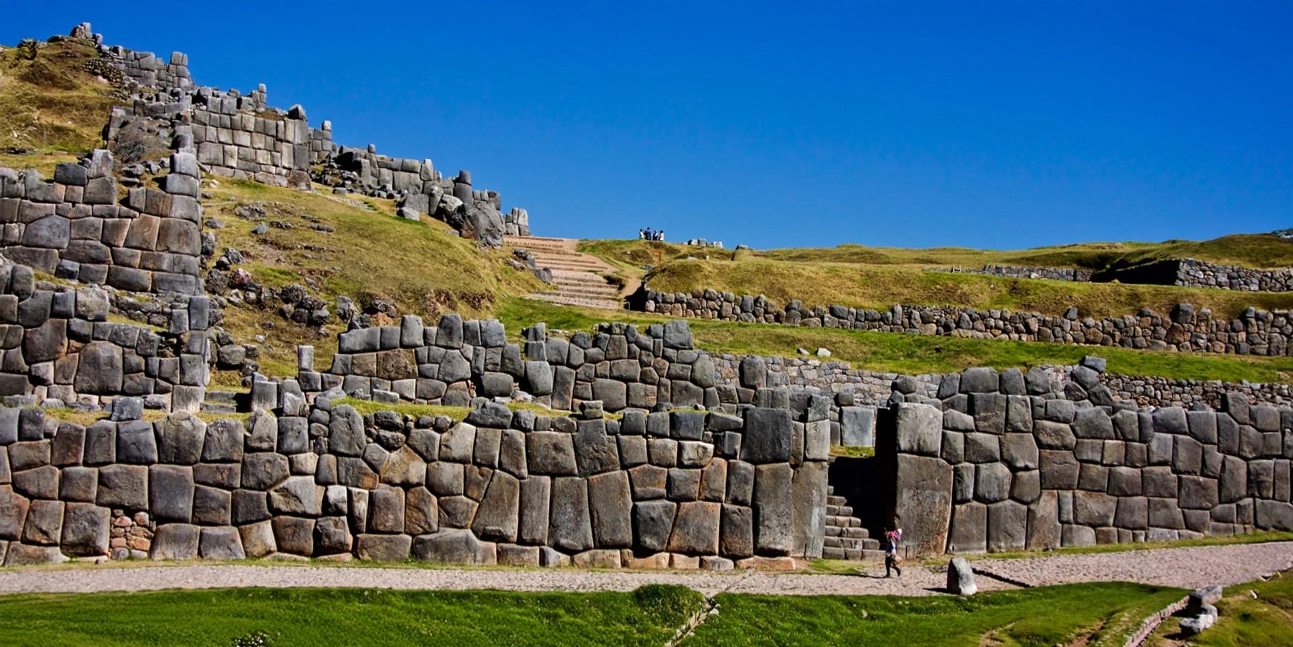 Massive zigzagging megalithic stone walls at the Sacsayhuaman archaeological site near Cusco.
