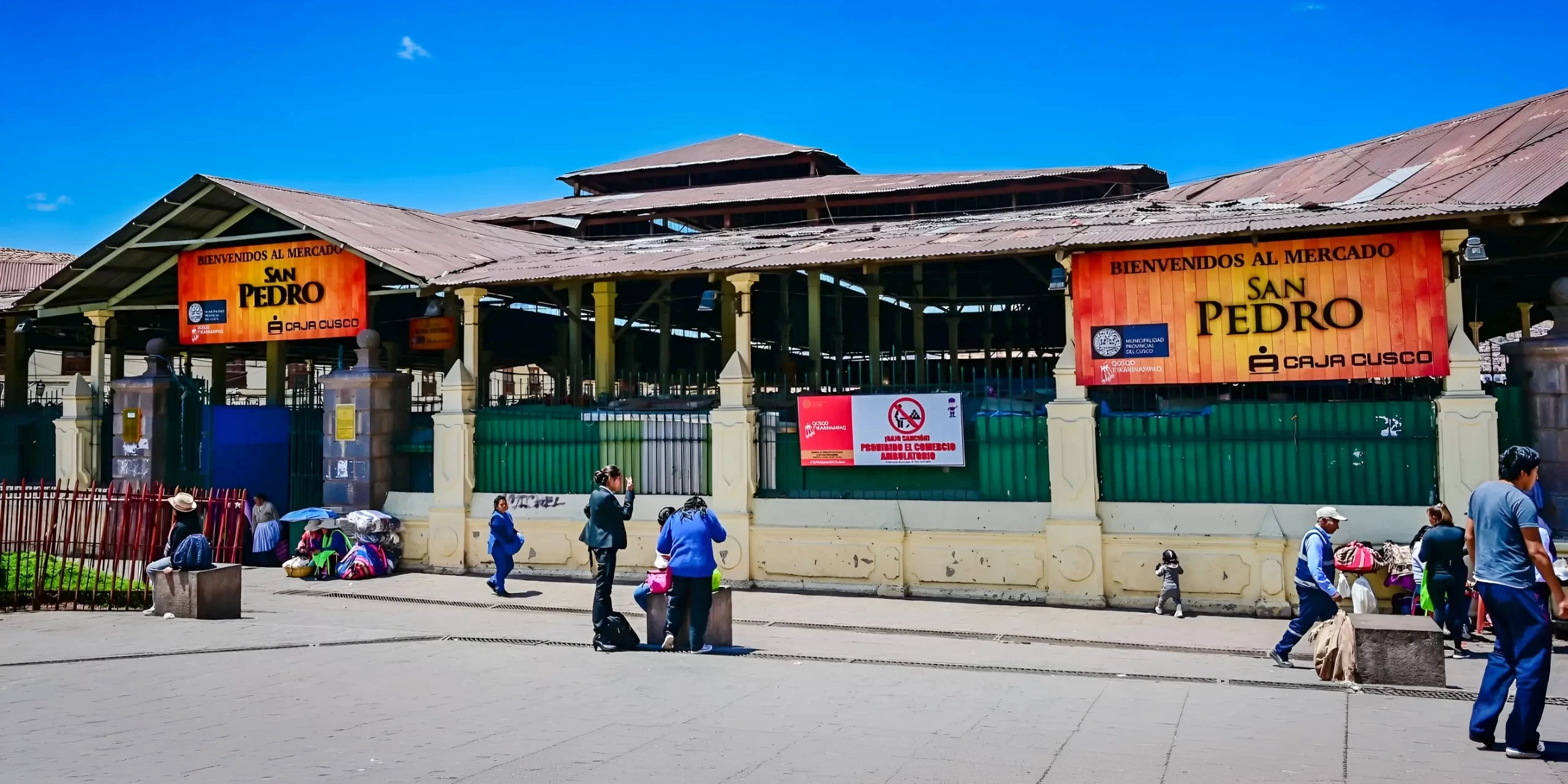 Panoramic view of the main entrance to San Pedro Market with the traditional orange welcome signs.