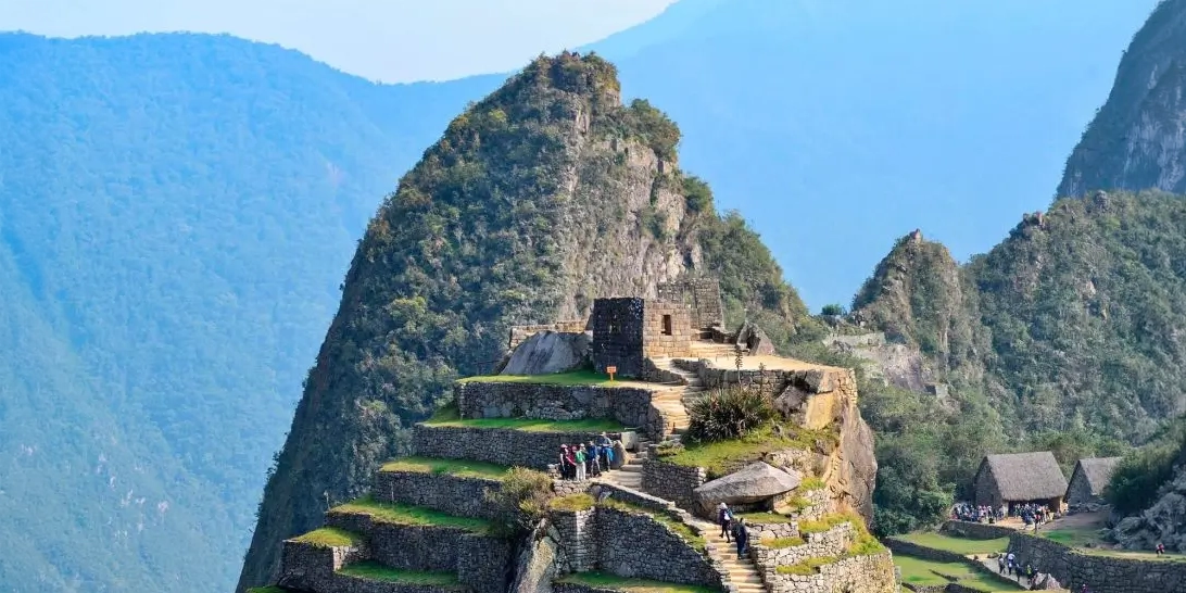 Intihuatana hill and agricultural terraces in the Inca citadel of Machu Picchu, Peru.