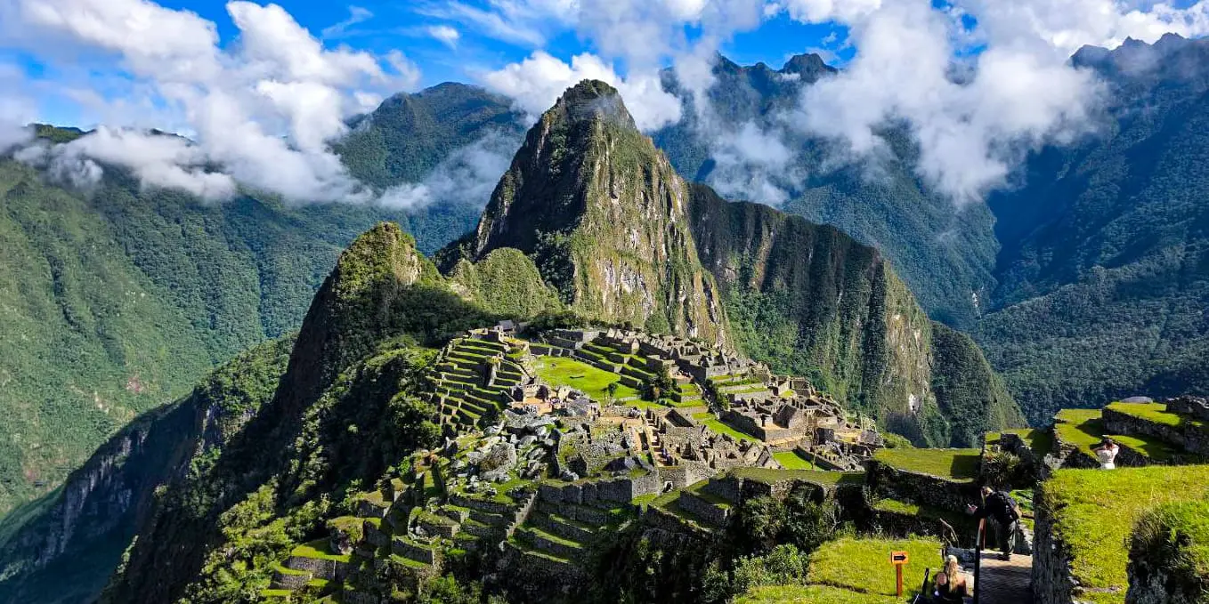 Full overhead view of the Machu Picchu archaeological site, showing the iconic peak and the complex of stone buildings.