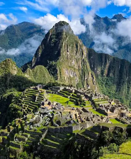 Full overhead view of the Machu Picchu archaeological site, showing the iconic peak and the complex of stone buildings.