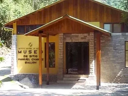 The stone and wood entrance of the Manuel Chávez Ballón Museum at the base of Machu Picchu mountain