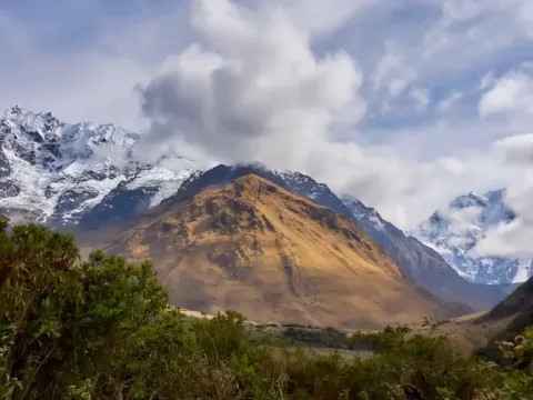 Landscape of the Andes mountains with clouds covering the snowy peaks.