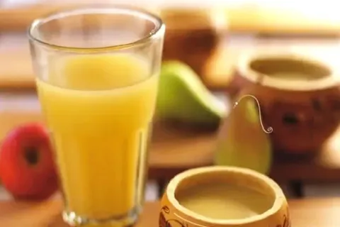 A tall glass of Chicha de Jora, a traditional fermented corn beer from Peru.