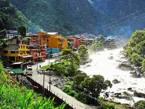 Colorful buildings and hotels built along the banks of the powerful Urubamba River in Aguas Calientes