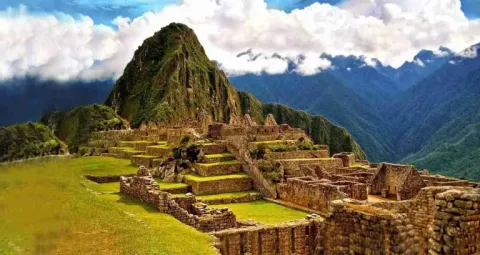 Explore the ruins of Machu Picchu, a World Heritage Site in the Peruvian Andes Panoramic view of the ancient Inca citadel of Machu Picchu and Huayna Picchu mountain under a cloudy sky