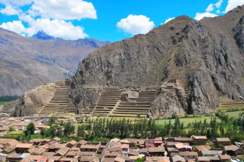 Wide view of the Ollantaytambo Inca fortress and the living Inca town nestled in the mountains of the Sacred Valley.