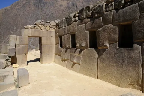 Detail of perfectly carved Inca stone walls and a stone doorway at the Ollantaytambo archaeological site in the Sacred Valley.