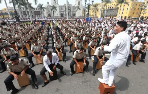 A large number of men playing the traditional Cajon instrument.