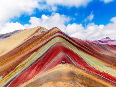 Rainbow Mountain Vinicunca - Cusco Vinicunca Rainbow Mountain with colorful mineral layers under a blue sky in Cusco, Peru.