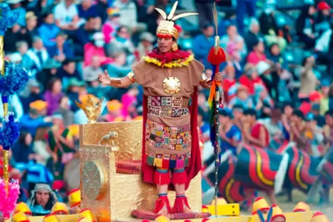 Close-up of the actor representing the Sapa Inca with arms open, greeting the crowd during the Sun Festival.