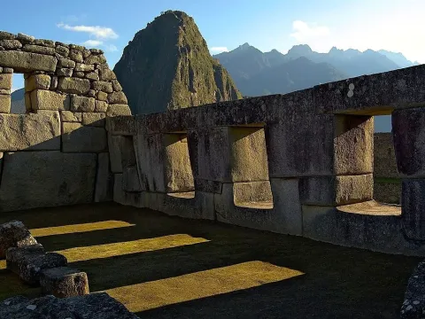 Interior of the Temple of the Three Windows at Machu Picchu, showing Inca masonry and a central pillar