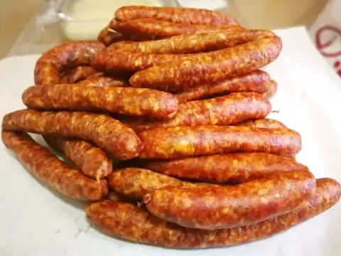 A stack of artisanal red chorizos from Cusco, a key ingredient in local traditional dishes like Chiriuchu.