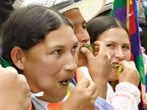 Local Peruvian women traditionally chewing coca leaves for energy and altitude sickness
