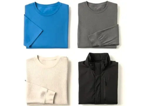 Assortment of T-shirts and a folded jacket, illustrating the layers of clothing for hiking