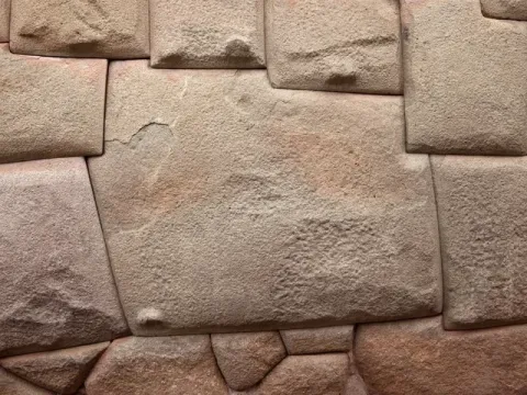 Close-up of the famous Twelve Angled Stone in a historic Inca wall in Cusco, Peru.