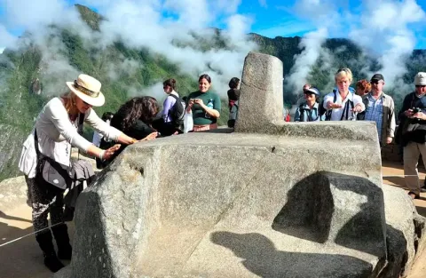 Panoramic view of the Intihuatana pyramid and surrounding terraces Carved stone structure of the Intihuatana dominating the Andean landscape in Machu Picchu