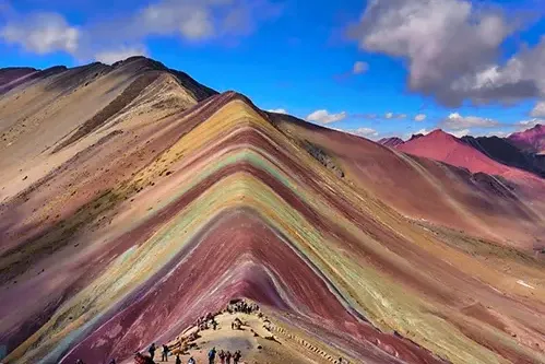 The iconic triangular peak of Vinicunca Rainbow Mountain during the Ausangate trek in Cusco, Peru.