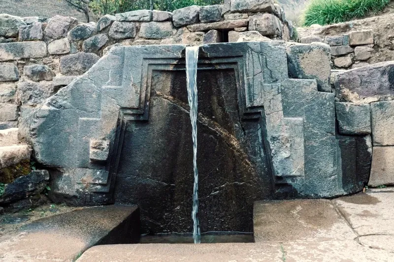 Ancient Inca water fountain known as the Bath of the Princess in the Ollantaytambo archaeological site.