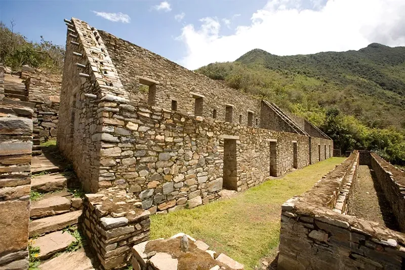 Close-up of the ancient stone walls and buildings at the Choquequirao ruins, showcasing the unique Inca architecture and construction style.