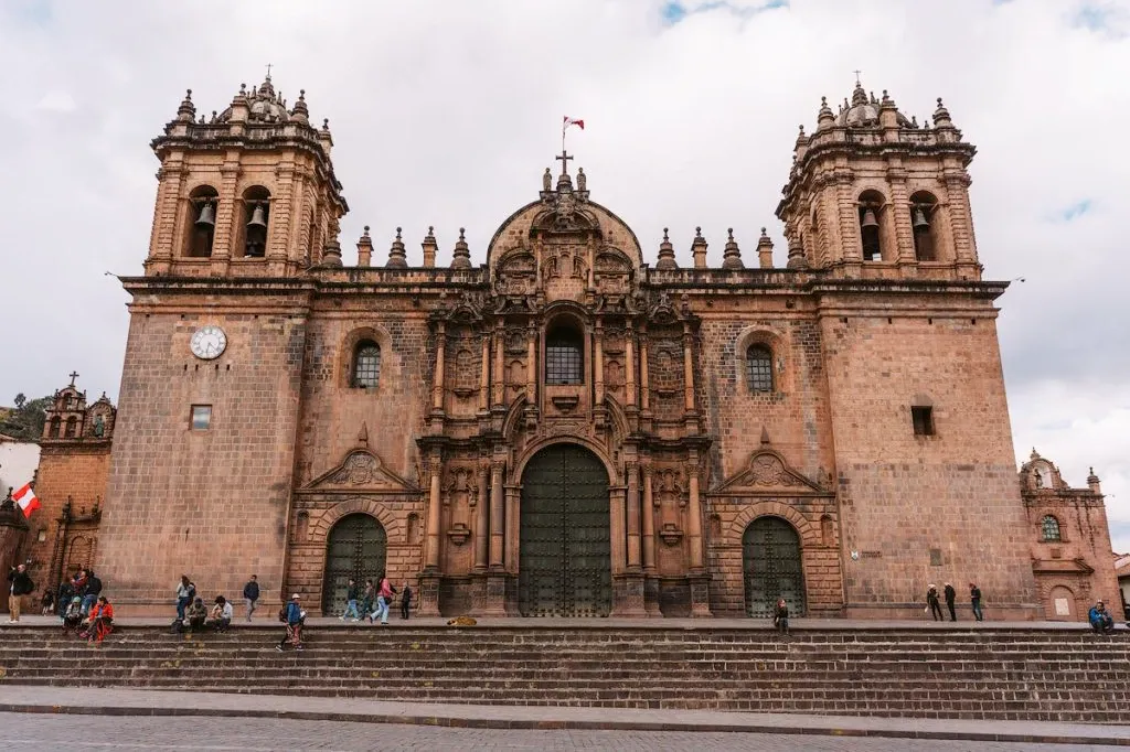 Full facade of the Cusco Cathedral at the Plaza de Armas featuring Renaissance and Baroque architectural styles.