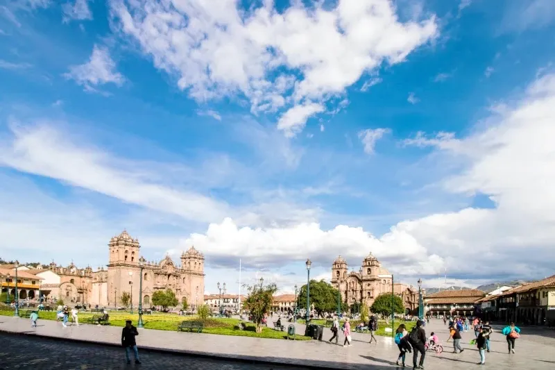 The Plaza de Armas in Cusco under a bright blue sky, the historic center of the Inca Empire and their astronomical studies.