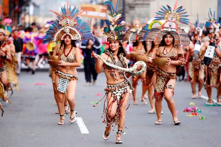 Peruvian dancers performing the Danza de la Boa (Snake Dance) with a live boa constrictor in the Amazon.