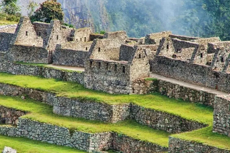 Detailed view of the stone agricultural terraces and residential ruins at the Machu Picchu archaeological site.