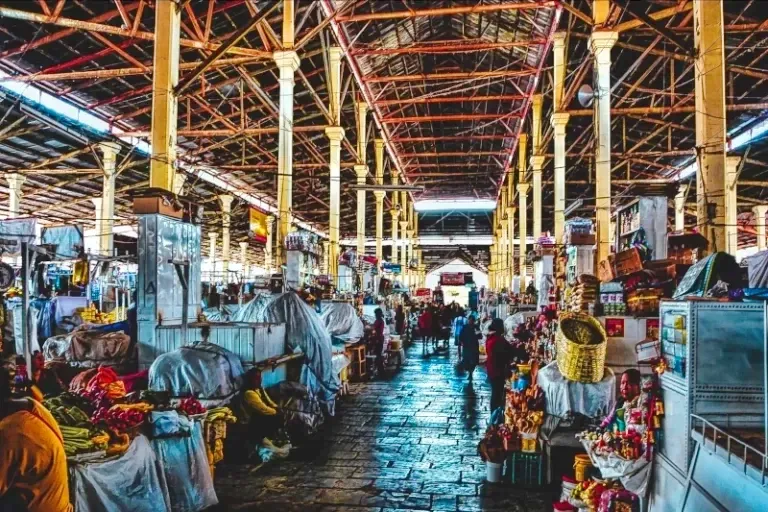 Interior view of the high metal roof and central aisles of the historic San Pedro Market in Cusco.