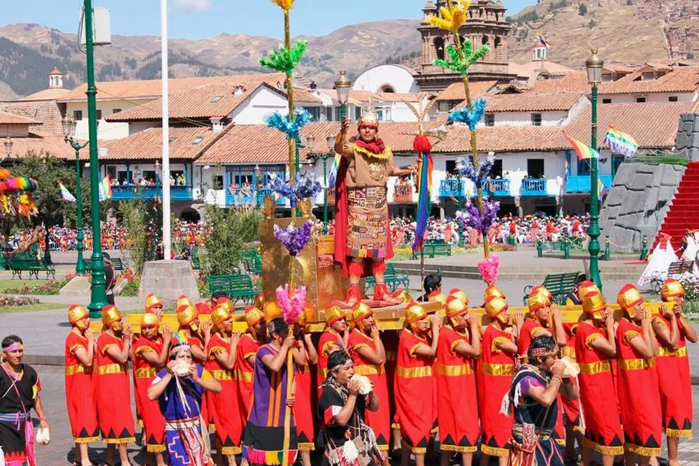 The Incan ruler being carried by dozens of subjects through the Plaza de Armas of Cusco during the Sun Festival.
