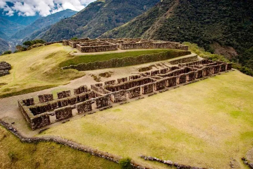 Overhead view of the stone structures and agricultural terraces at the Vilcabamba archaeological complex in Peru.