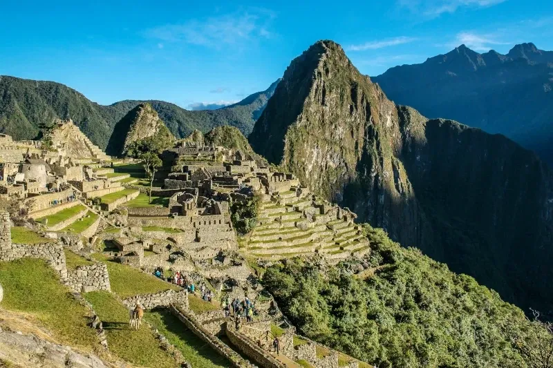 A classic panoramic view of the Machu Picchu citadel with the Huayna Picchu mountain rising behind the ruins.