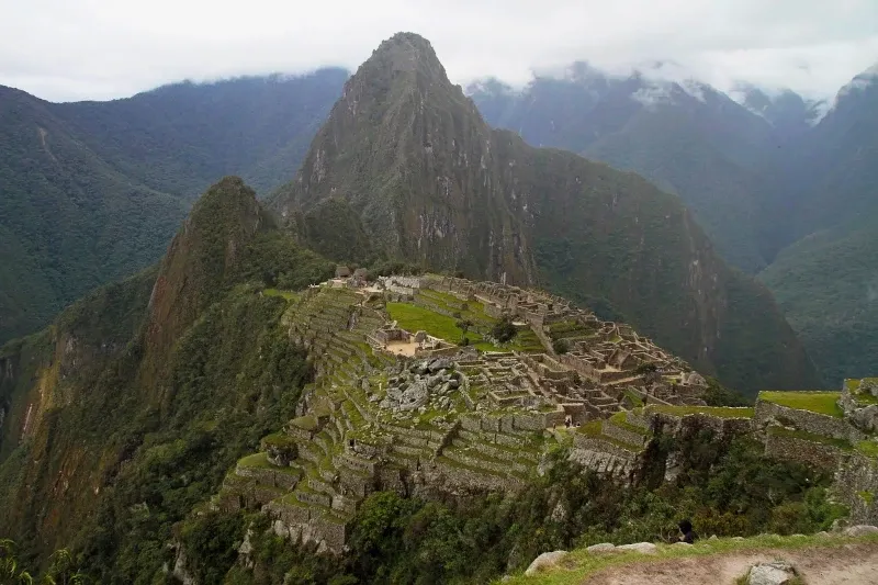 Wide panoramic view of the Machu Picchu archaeological site with Huayna Picchu mountain in the background.