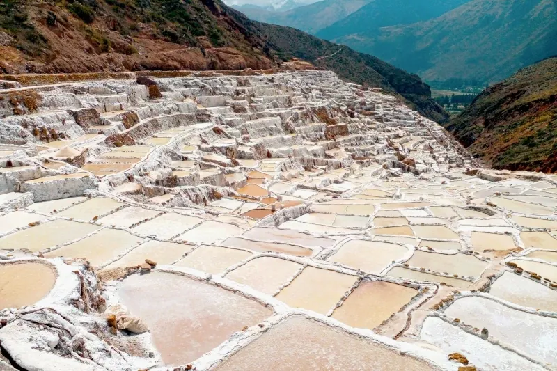A panoramic view of the ancient salt evaporation ponds carved into the side of a mountain in the Sacred Valley.