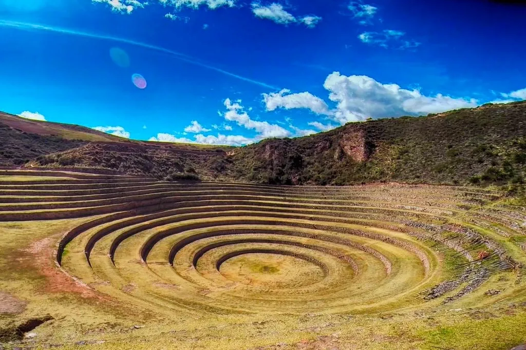 Detailed shot of the concentric stone circles at Moray with a bright blue sky and scattered clouds.