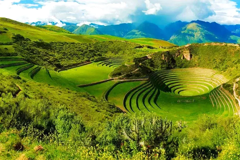 Stunning aerial view of the circular agricultural terraces of Moray, an ancient Inca laboratory used for crop experimentation in the Sacred Valley.