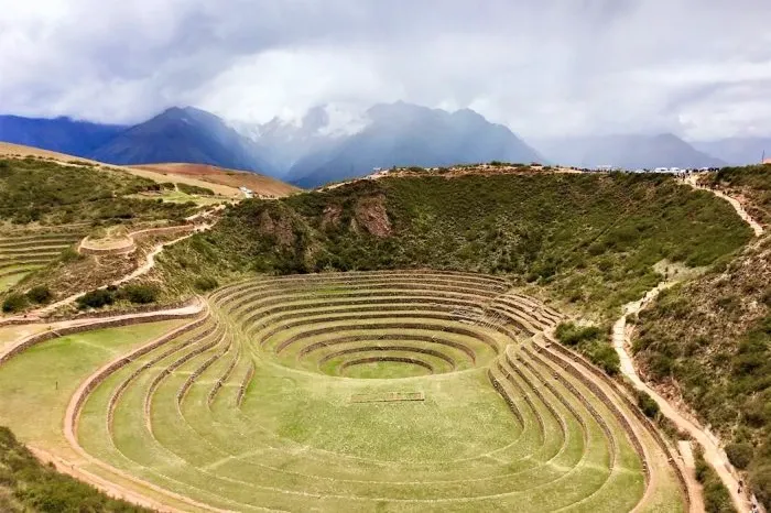 Perspective shot of the deep circular depressions and terraces at the Moray archaeological site.