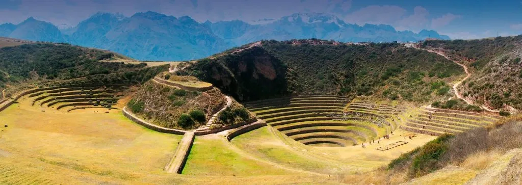 Wide horizontal panorama of the entire Moray complex showing multiple circular terrace systems.