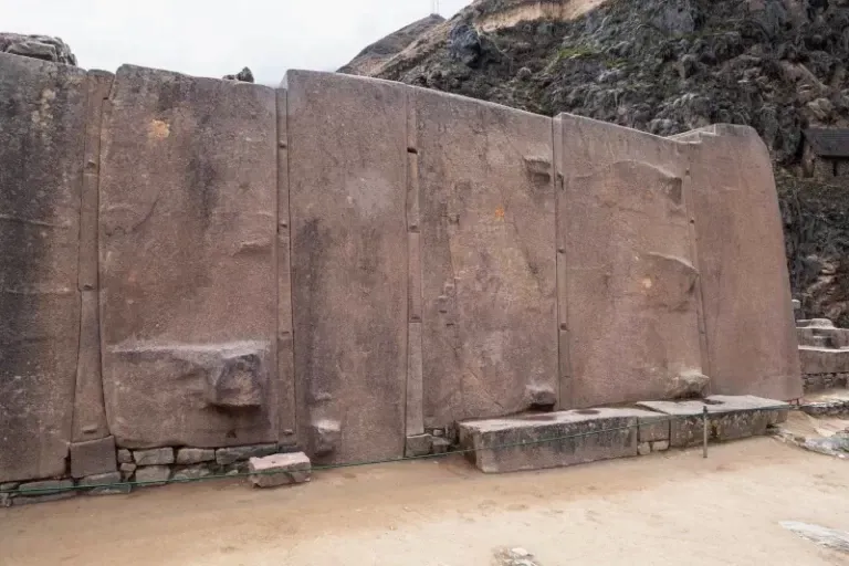 Close-up of the Temple of the Sun's massive pink granite wall at Ollantaytambo fortress.