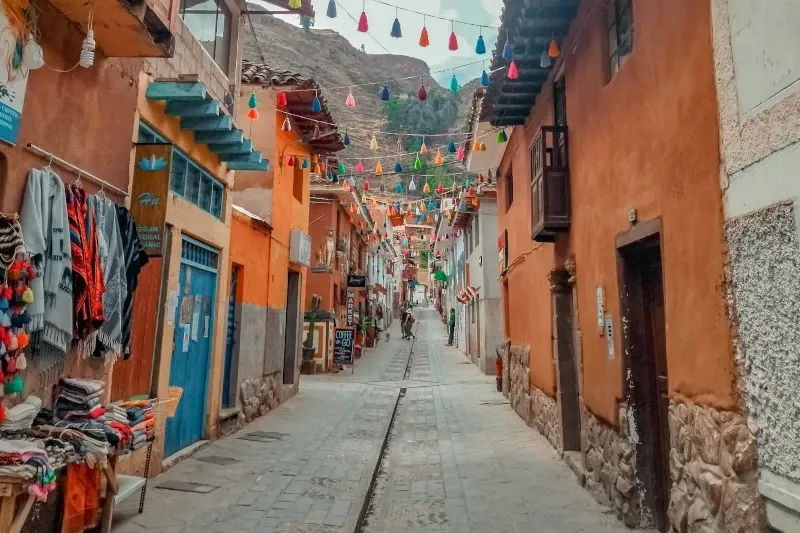 Traditional Streets of Pisac Village A narrow traditional street in Pisac decorated with colorful hanging ornaments and local craft shops.