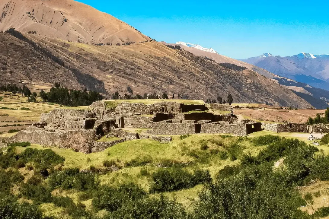 Panoramic view of Puca Pucara fortress with Andean mountains in the background.
