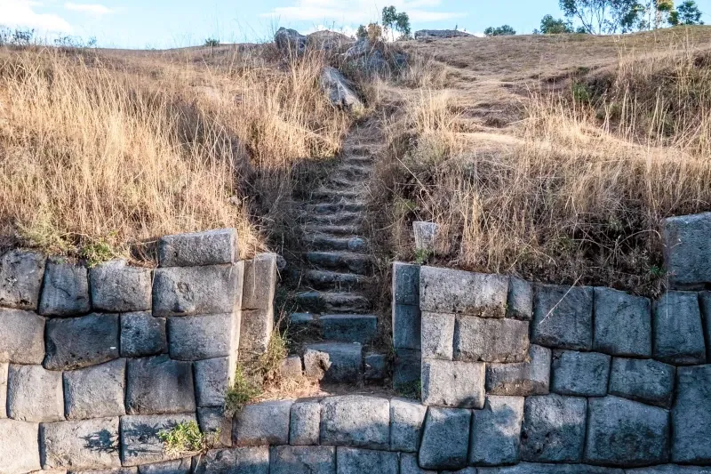 Small stone steps leading through the ancient carved rock structures at Qenqo.
